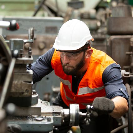 Male engineer working a machine - how to master the job market